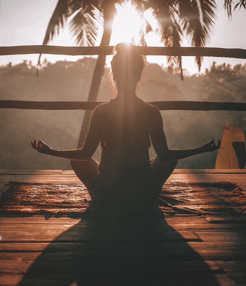 Person meditating in a calm, sunlit space